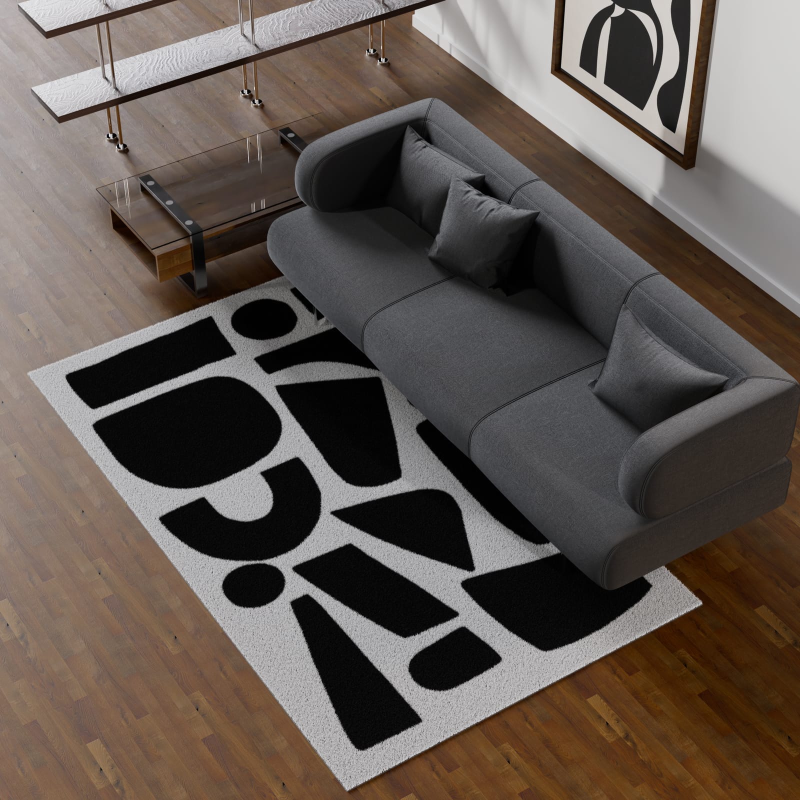 Tappeto bianco con forme nere astratte accanto a un divano grigio
